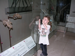 Peo taking her photo of the homo erectus skull.